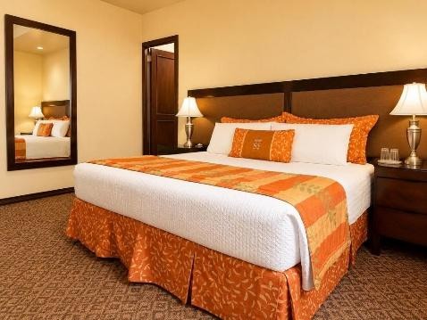 Habitación amplia con cama king y espejo de cuerpo entero