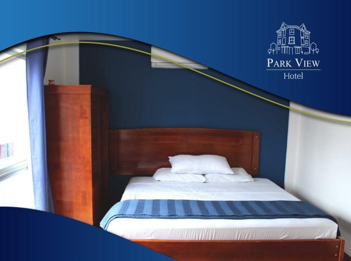 Habitación con cama matrimonial y armario de madera